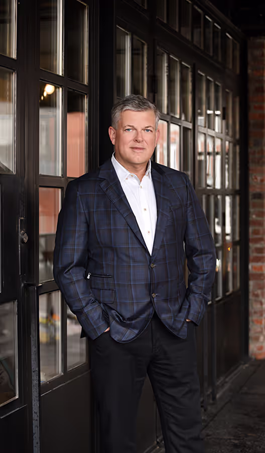 Portrait of the founder of Targeted Coaching International, standing confidently in a professional setting.