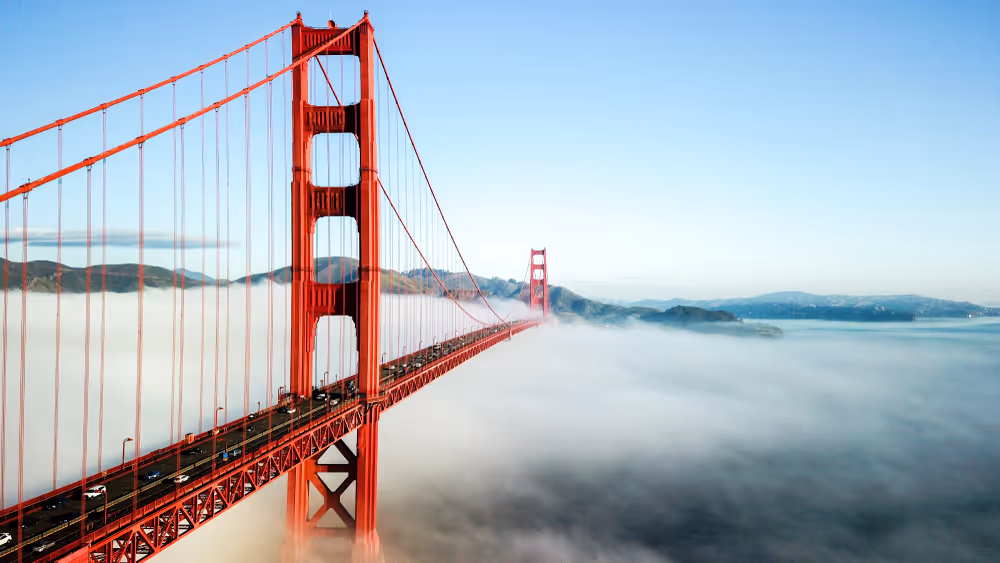 View of Golden Gate Bridge in San Francisco, rising through the clouds — symbolizing clarity, elevation, and executive leadership